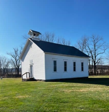 A white one-room schoolhouse